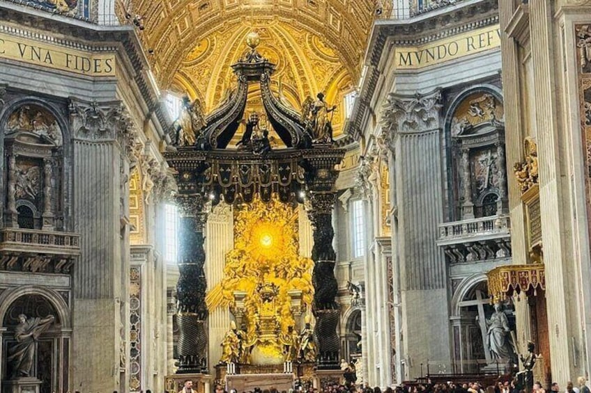 An ornate church interior with golden decorations and statues. 1