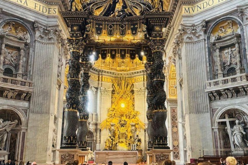 An ornate religious interior with golden statues and intricate carvings. 5