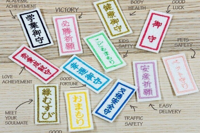 Various colored tags with Japanese characters and English phrases like 'victory,' 'good health,' and 'easy delivery.' 2