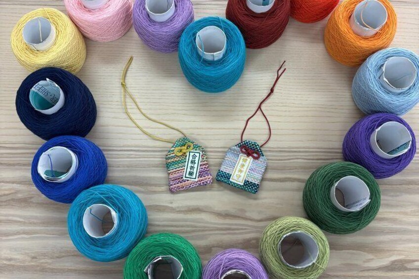 Colorful spools of yarn arranged in a circle on a wooden surface. 5
