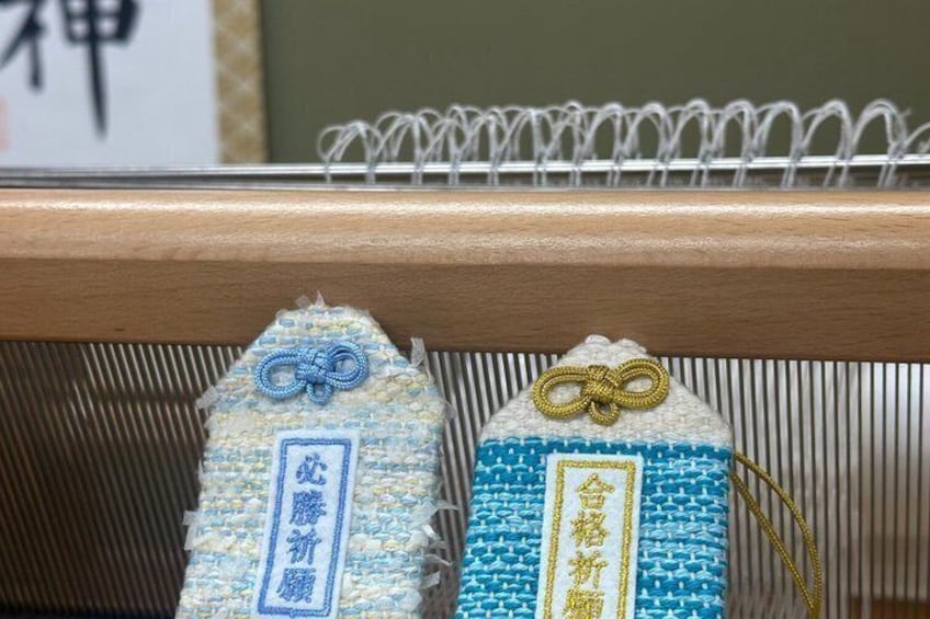 Two woven tags with Japanese characters and a metal bar. 4