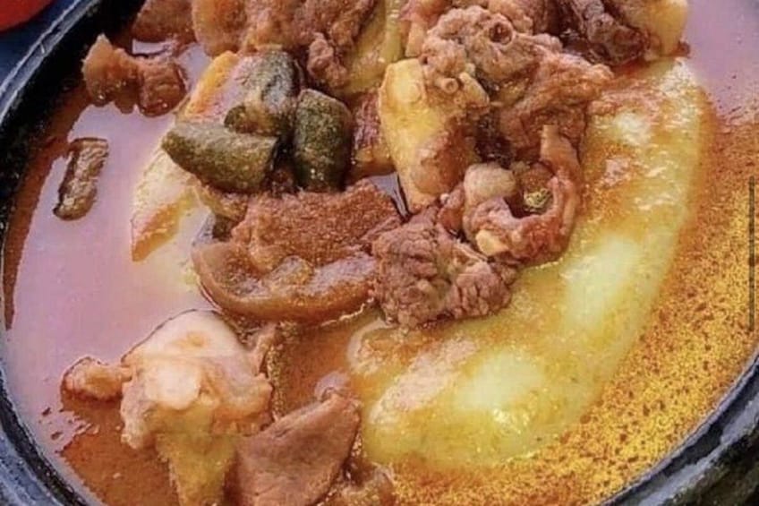 A close-up of a spicy stew with various meats and vegetables. 2