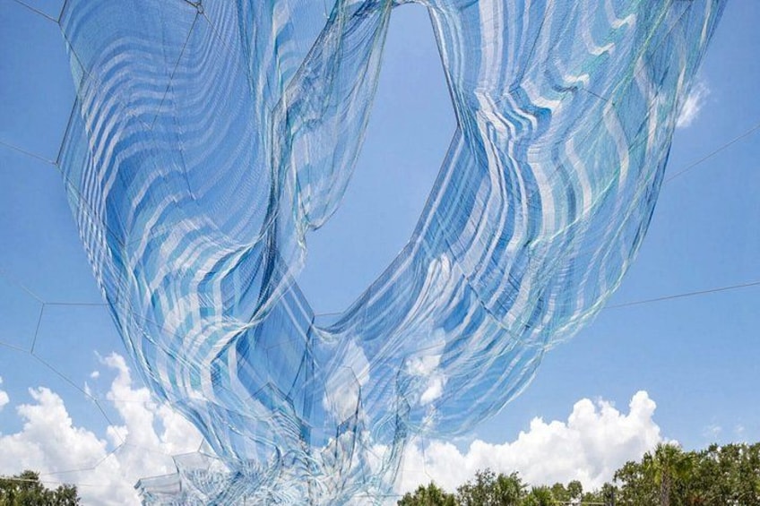A large, translucent fabric structure against a clear sky. 5