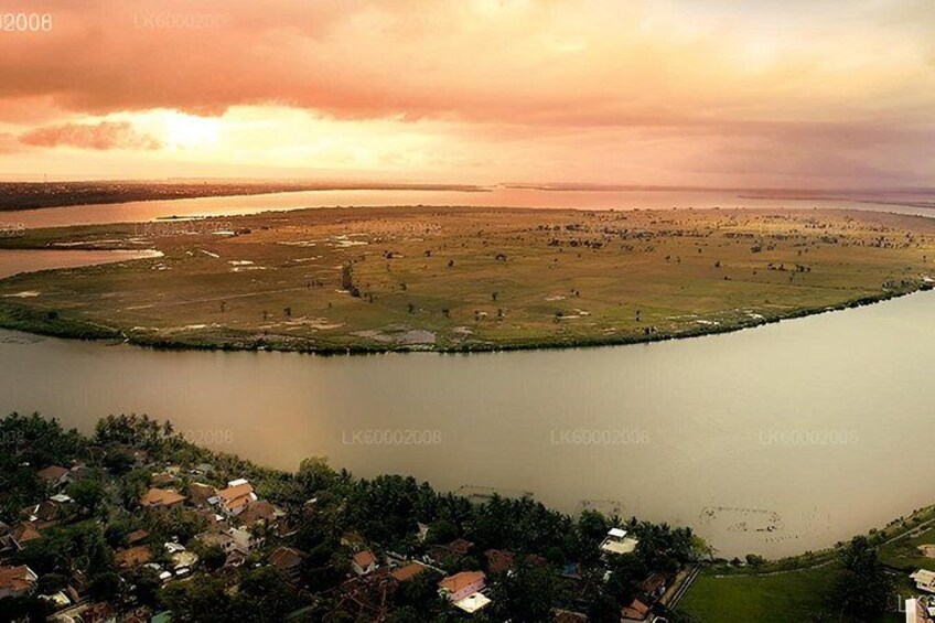 A river meandering through a landscape with a small settlement at its edge. 2