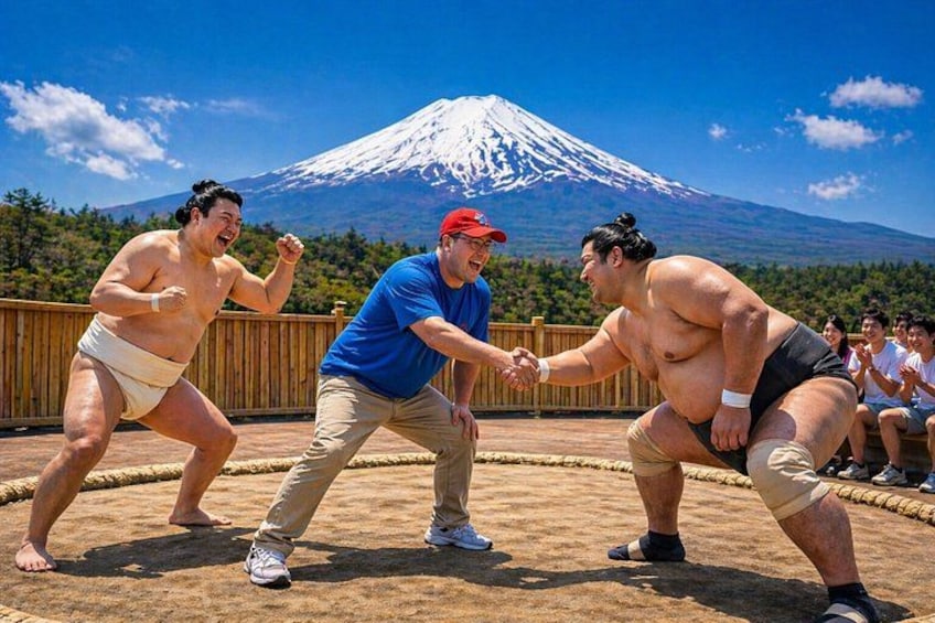 Two sumo wrestlers in a ring with a mountain in the background. 2