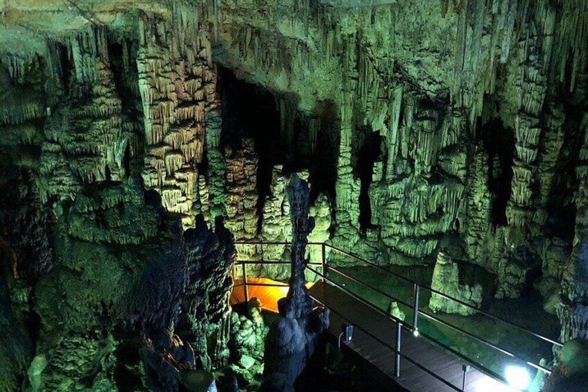 A cave with stalactites and a walkway. 4
