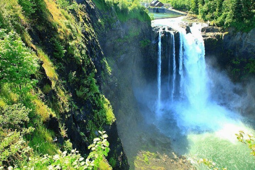 A waterfall cascading down a steep cliff surrounded by lush greenery. 3