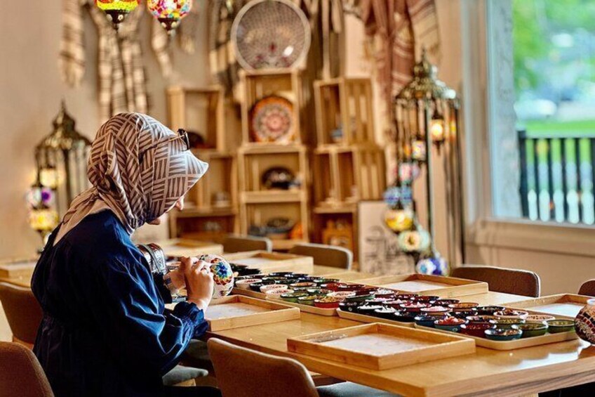 A person playing a board game at a table with various game pieces and a board. 1