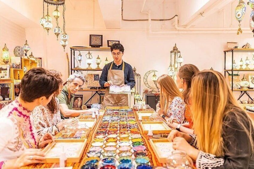 A jewelry workshop with a display of colorful jewelry and a person standing at the counter. 3