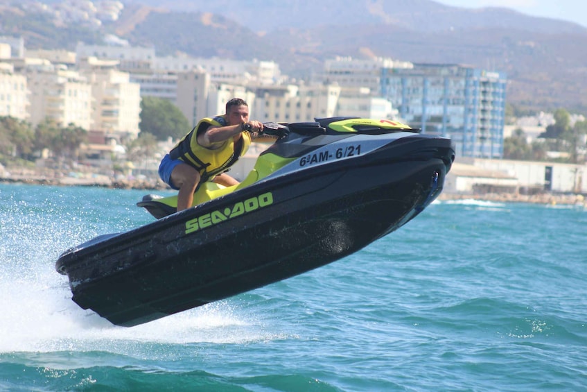 A person jet-skiing on a Sea-Doo jet ski with the number 6AM-621. 4