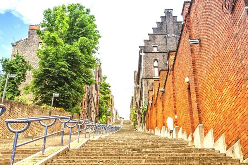 A staircase leading up to a building with a brick facade. 5