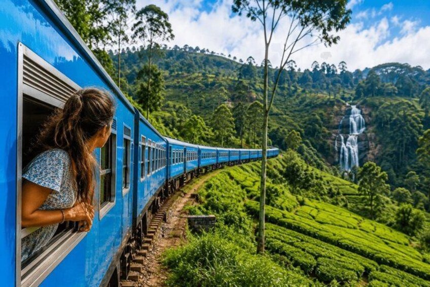 A train traveling through a lush green landscape with a waterfall in the background. 5