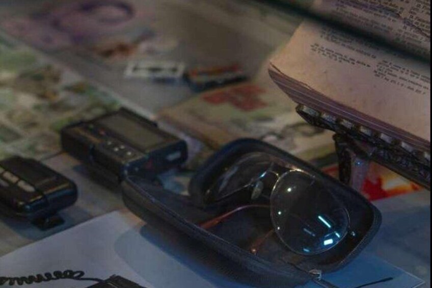 A pair of sunglasses, a wallet, and a credit card on a table. 4