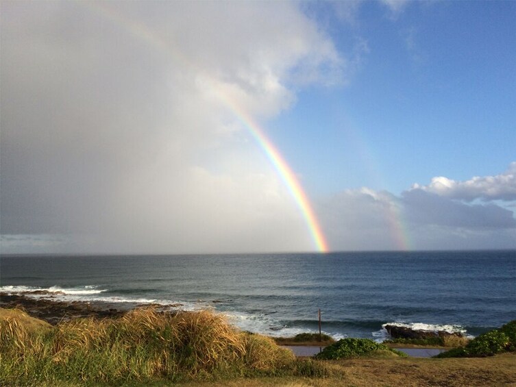 A coastal landscape with a rainbow over the ocean. 3
