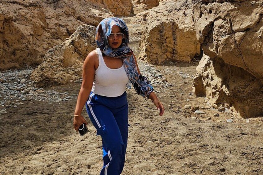 A person walking in a rocky desert landscape. 3