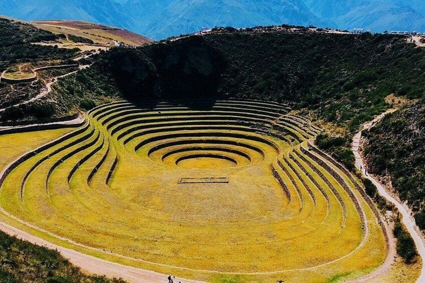 Terraced fields, a central structure, and a mountainous backdrop. 2