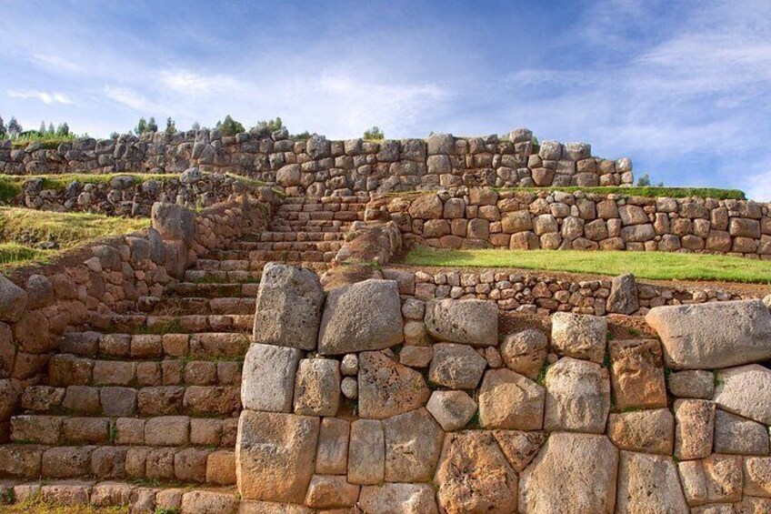 Ancient stone ruins with stepped terraces and walls. 4