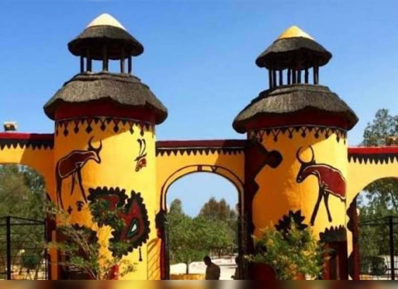 A building with two towers and a large archway, adorned with animal motifs. 5