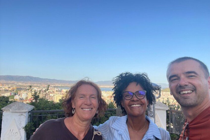 Three people standing with a cityscape in the background. 5