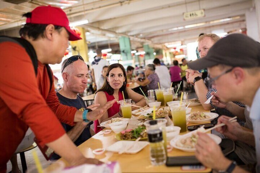 A group of people dining at a restaurant with various dishes and drinks on the table. 3