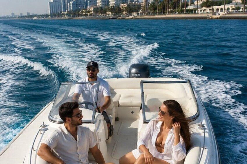 A boat with three people on the water, a cityscape in the background, and a sandy beach. 5