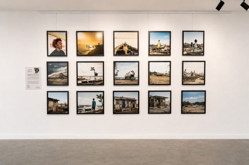 A gallery wall with framed photographs depicting various landscapes and scenes. 3