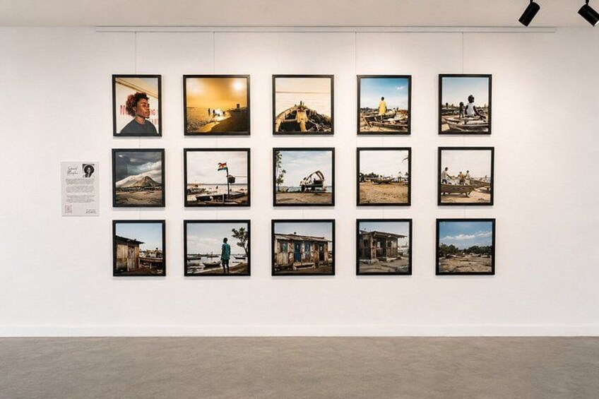 A gallery wall with multiple framed photographs. 3