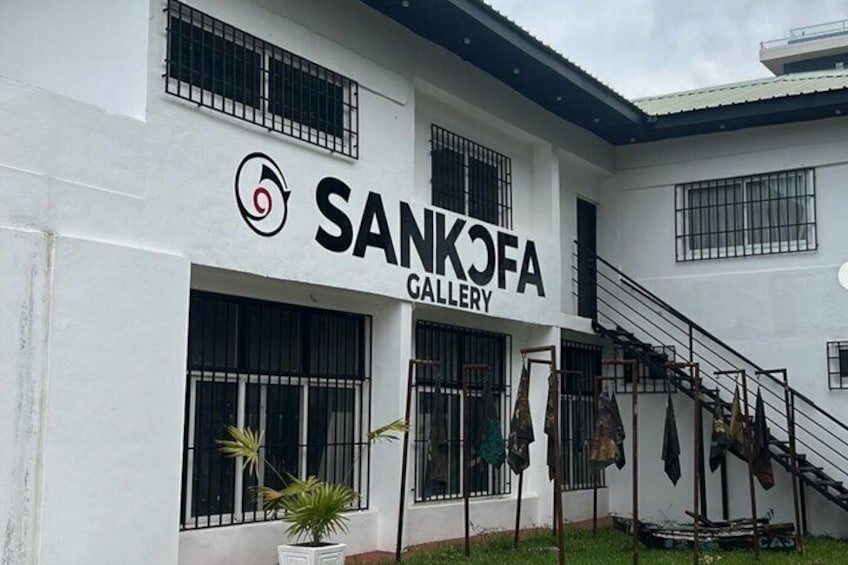 A building with a sign reading 'SANKOFA GALLERY' and a staircase leading to the entrance. 5