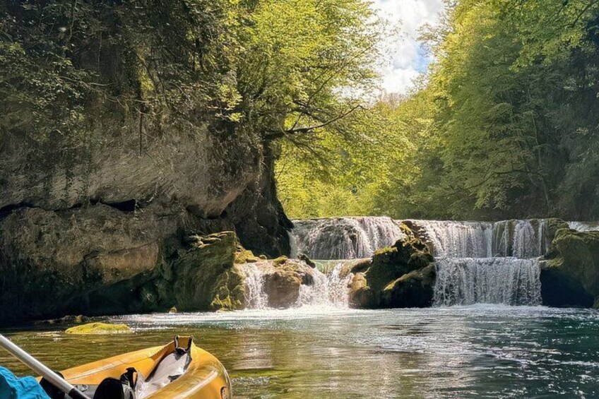 A waterfall, a river, and a kayak. 3