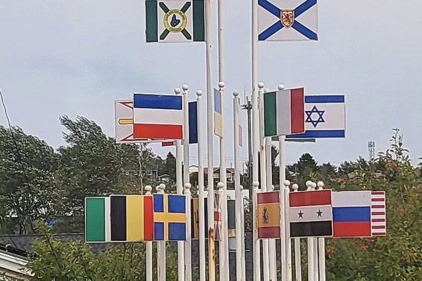 A flagpole with multiple national flags. 4