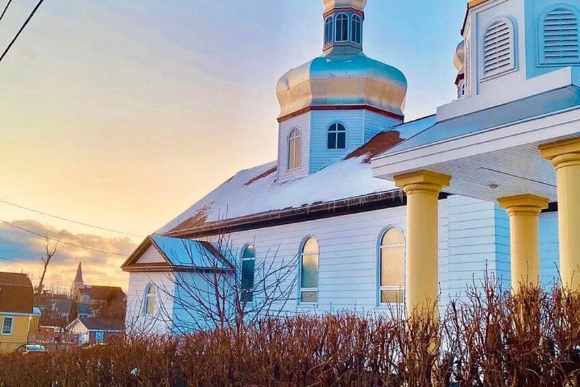 A church with a blue dome and yellow columns. 3