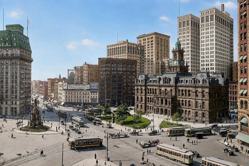 A cityscape with historic buildings, a central square, and tram lines. 2
