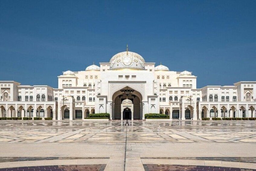 A large white building with a central dome and arches, surrounded by a courtyard. 4