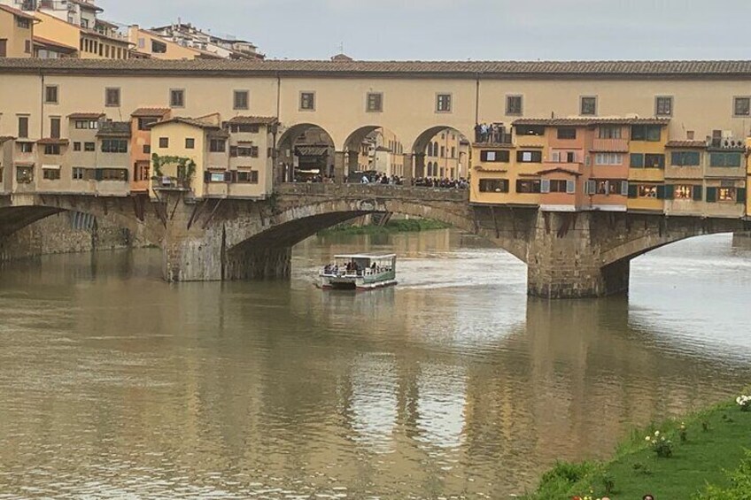 A river with a bridge, buildings, and a boat. 3