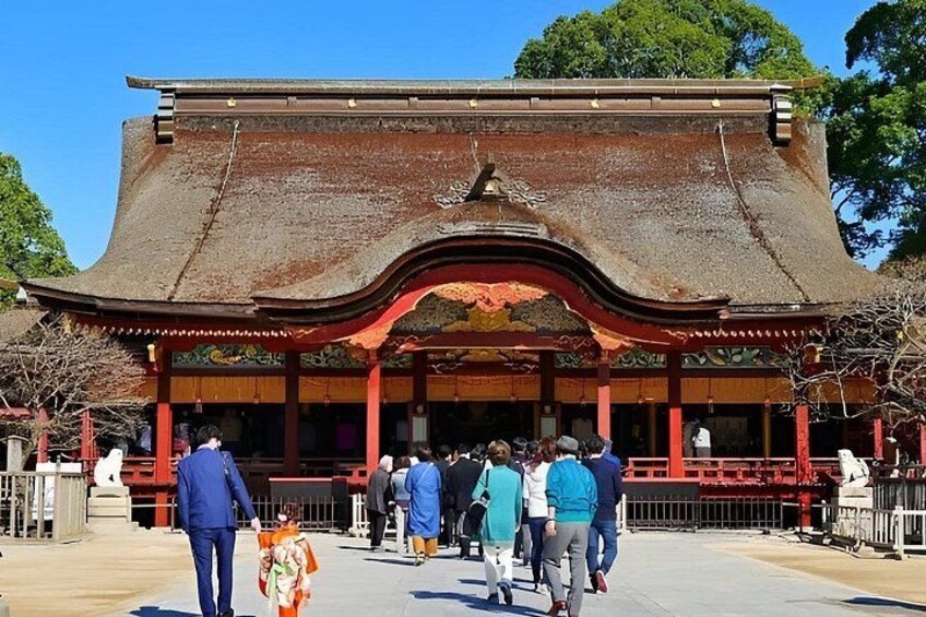 A traditional Japanese building with a curved roof and red pillars. 4