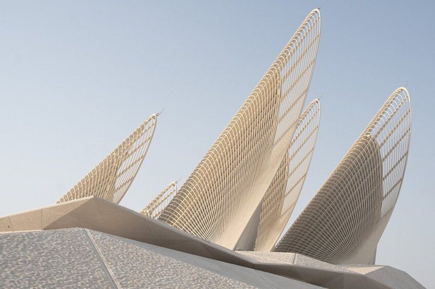 A modern architectural structure with a unique wing-like design. 4