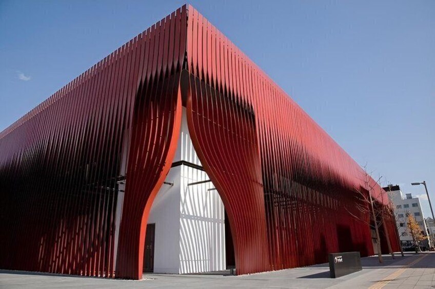 A red metal building with a white entrance. 3