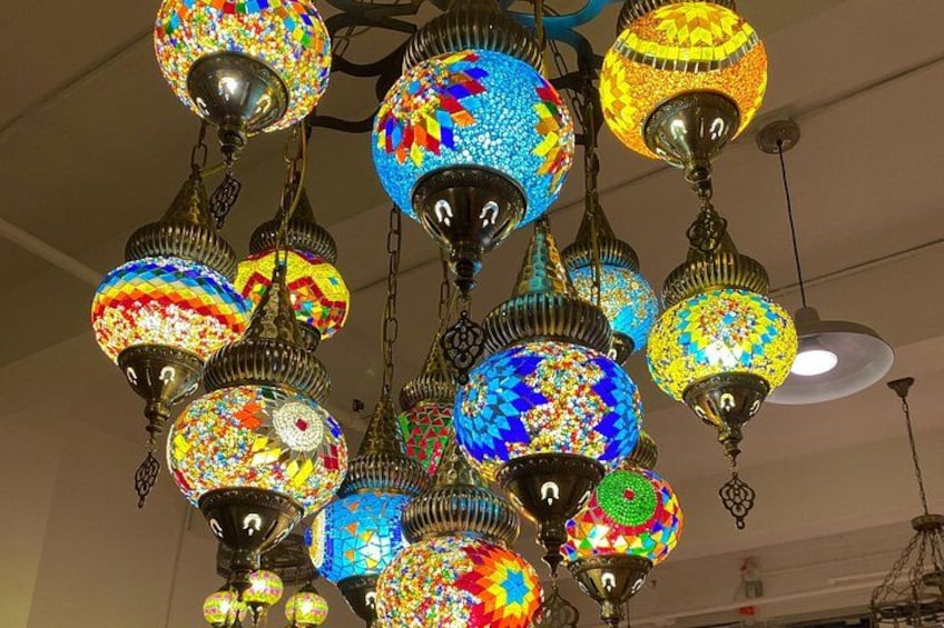 A chandelier with colorful, mosaic-patterned lampshades. 1