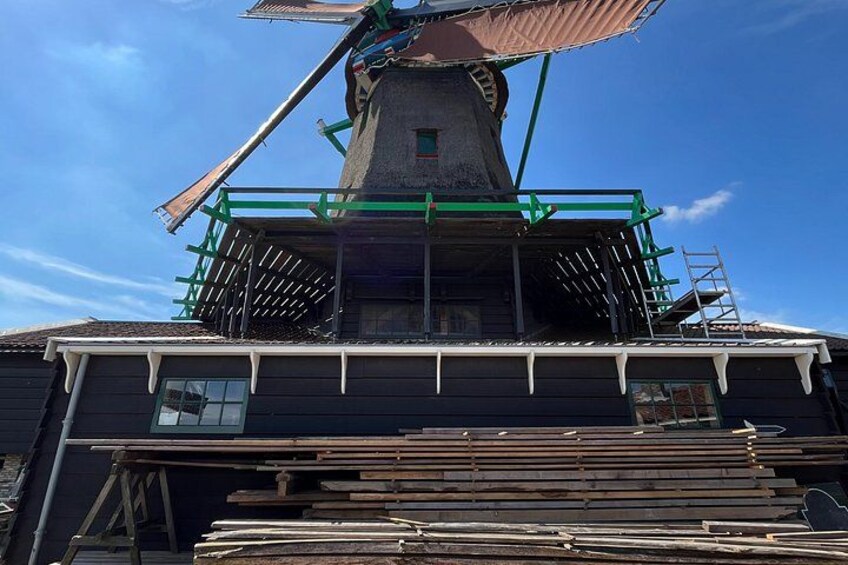A windmill with scaffolding and construction materials. 2