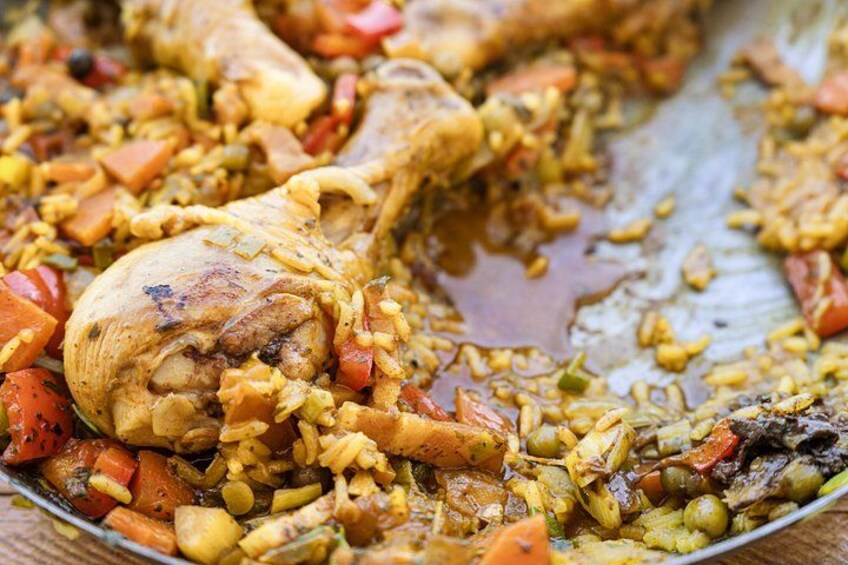 A dish with chicken, rice, and vegetables. 4