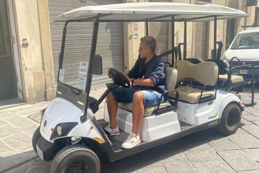 A golf cart with a person sitting in it. 3