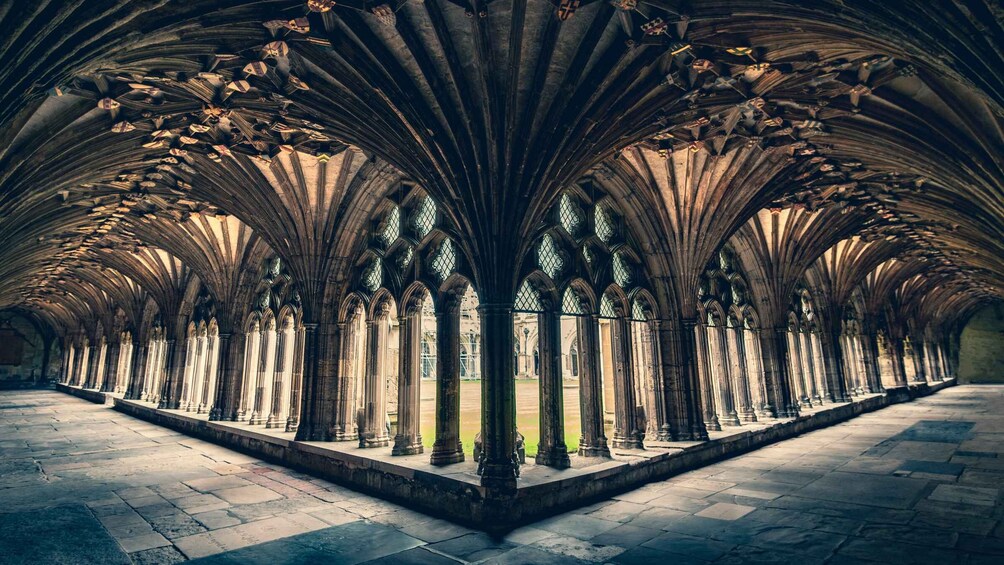 A cathedral's interior with pointed arches, ribbed vaults, and a series of columns. 4