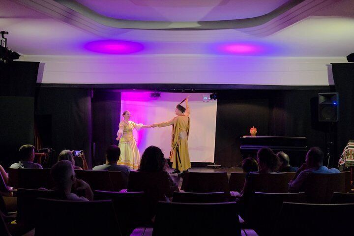 A theater with an audience watching a performance. 2