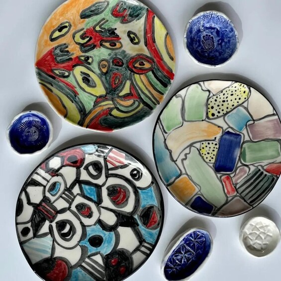 A collection of colorful ceramic tiles with various patterns and designs. 1