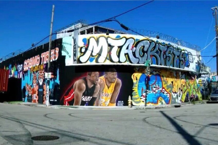 A building with vibrant graffiti art, including basketball players and the word 'MTA.' 3