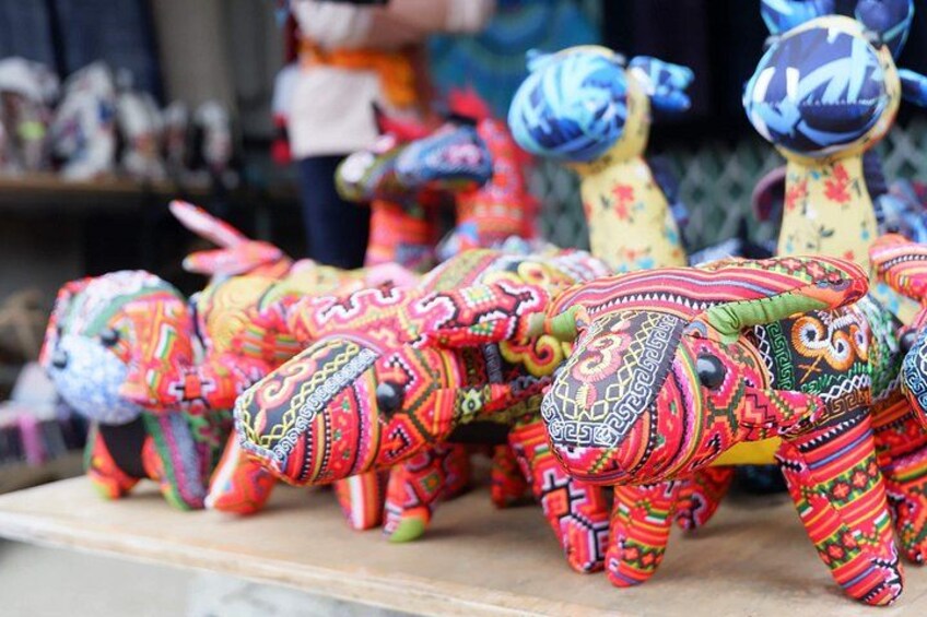 A collection of colorful, intricately embroidered elephant-shaped objects. 4