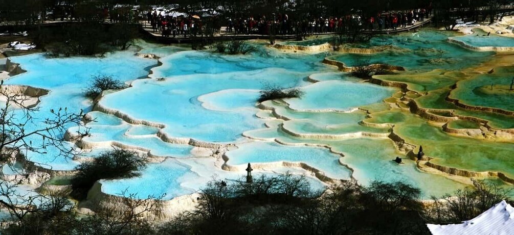A terraced hot spring area with clear turquoise pools. 2