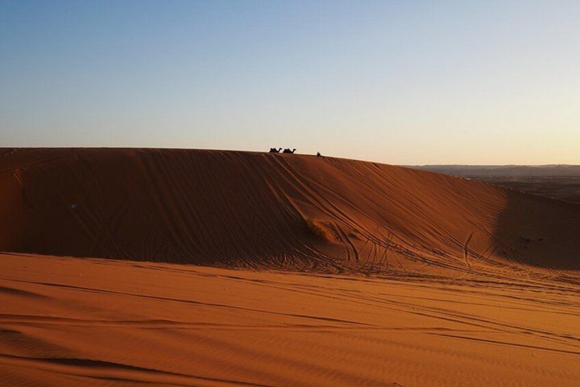 A desert landscape with sand dunes and a clear sky. 2
