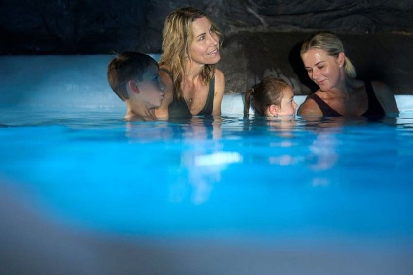 A swimming pool with people in it. 5