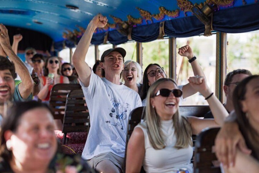 People on a bus with raised hands, possibly cheering or celebrating. 2